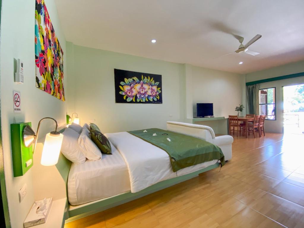 a bedroom with a bed and a living room at Cruiser Island By Swiss-Belhotel in Ko Lone