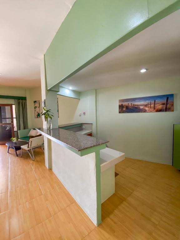 a kitchen with a counter top in a living room at Cruiser Island By Swiss-Belhotel in Ko Lone