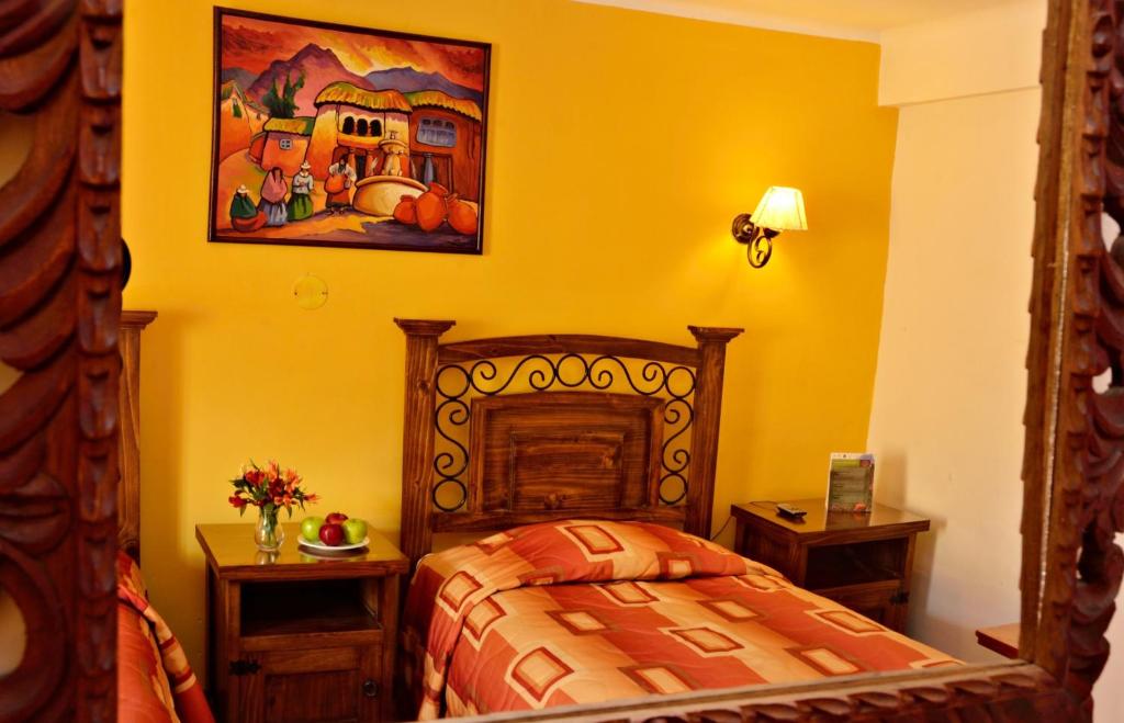 Postel nebo postele na pokoji v ubytování Hostal Mallqui