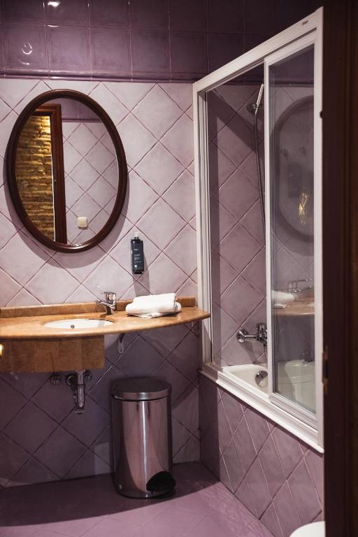 a bathroom with a sink and a mirror at San Sebastián DOT Rooms in San Sebastián