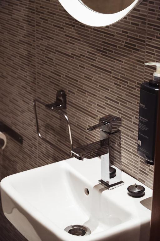 a bathroom sink with a hair dryer on it at San Sebastián DOT Rooms in San Sebastián