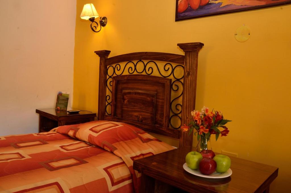 Postel nebo postele na pokoji v ubytování Hostal Mallqui