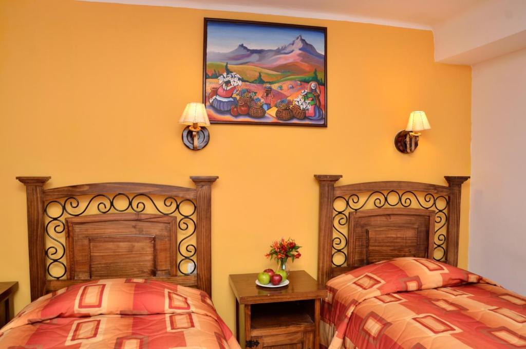 Postel nebo postele na pokoji v ubytování Hostal Mallqui