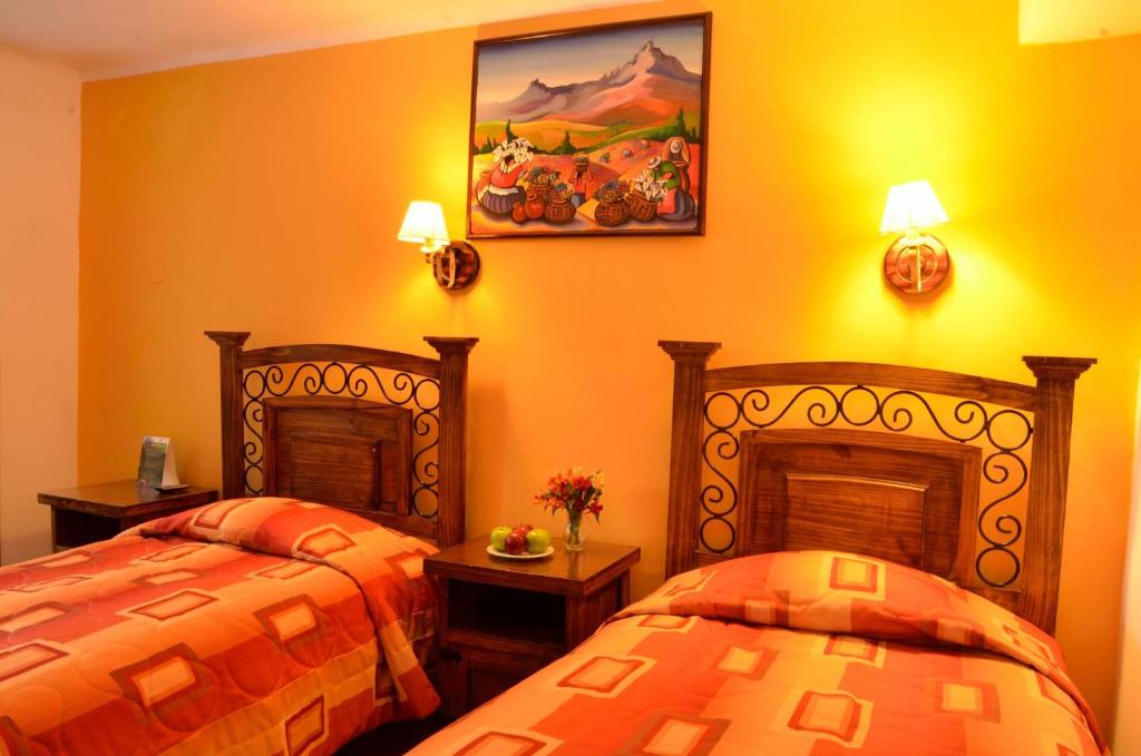 Postel nebo postele na pokoji v ubytování Hostal Mallqui
