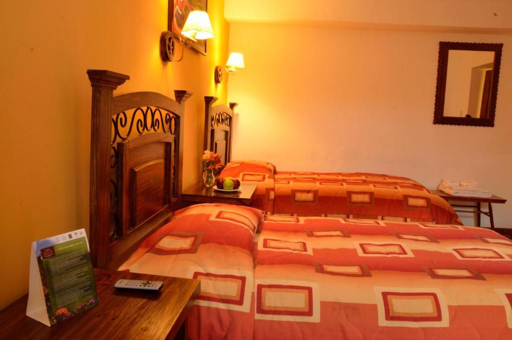 Postel nebo postele na pokoji v ubytování Hostal Mallqui