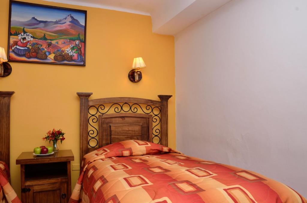 Postel nebo postele na pokoji v ubytování Hostal Mallqui