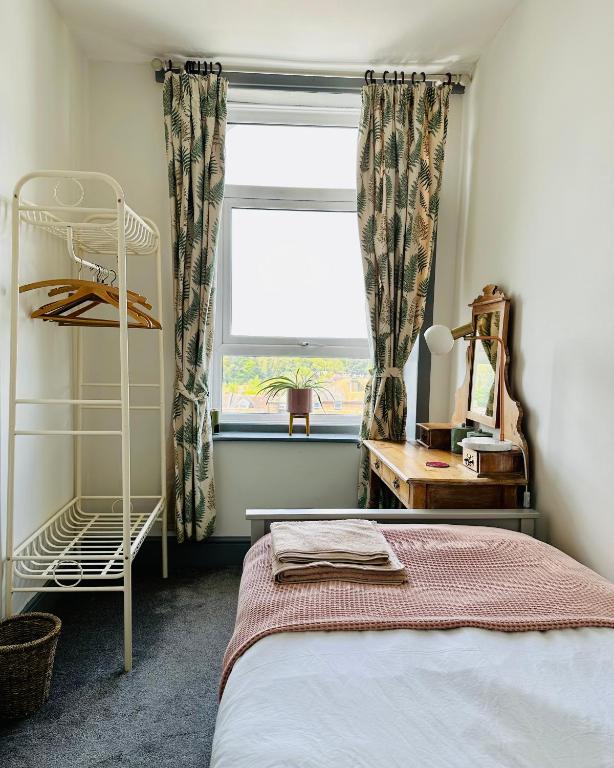 a bedroom with a bed and a window at CloudZen in Kent