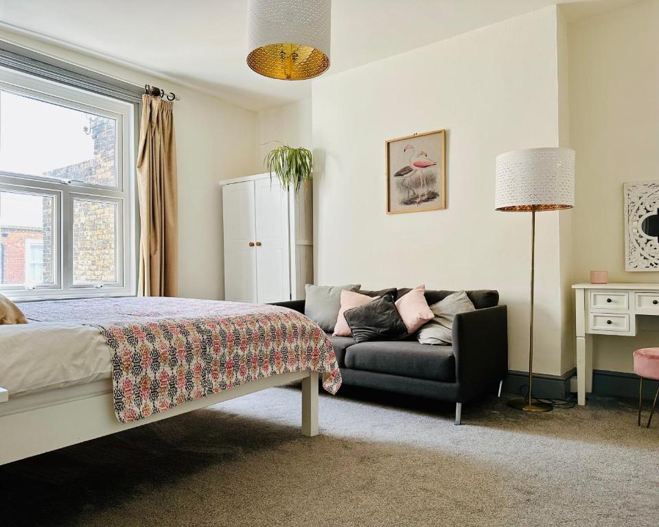 a bedroom with a bed and a couch at CloudZen in Kent