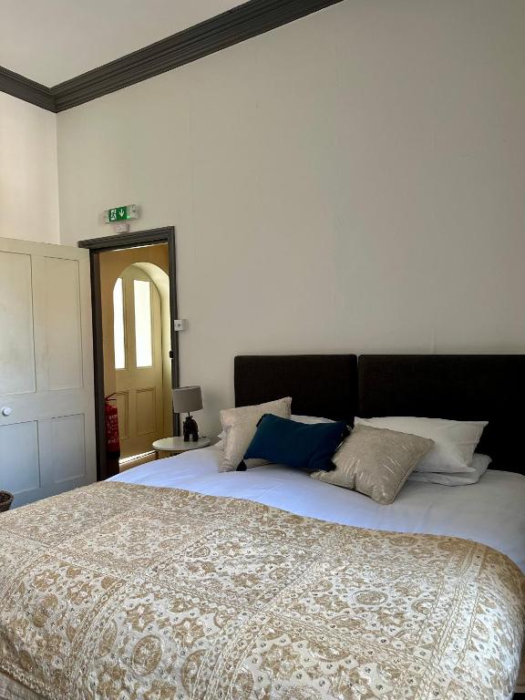 a bedroom with a large bed with pillows on it at CloudZen in Kent