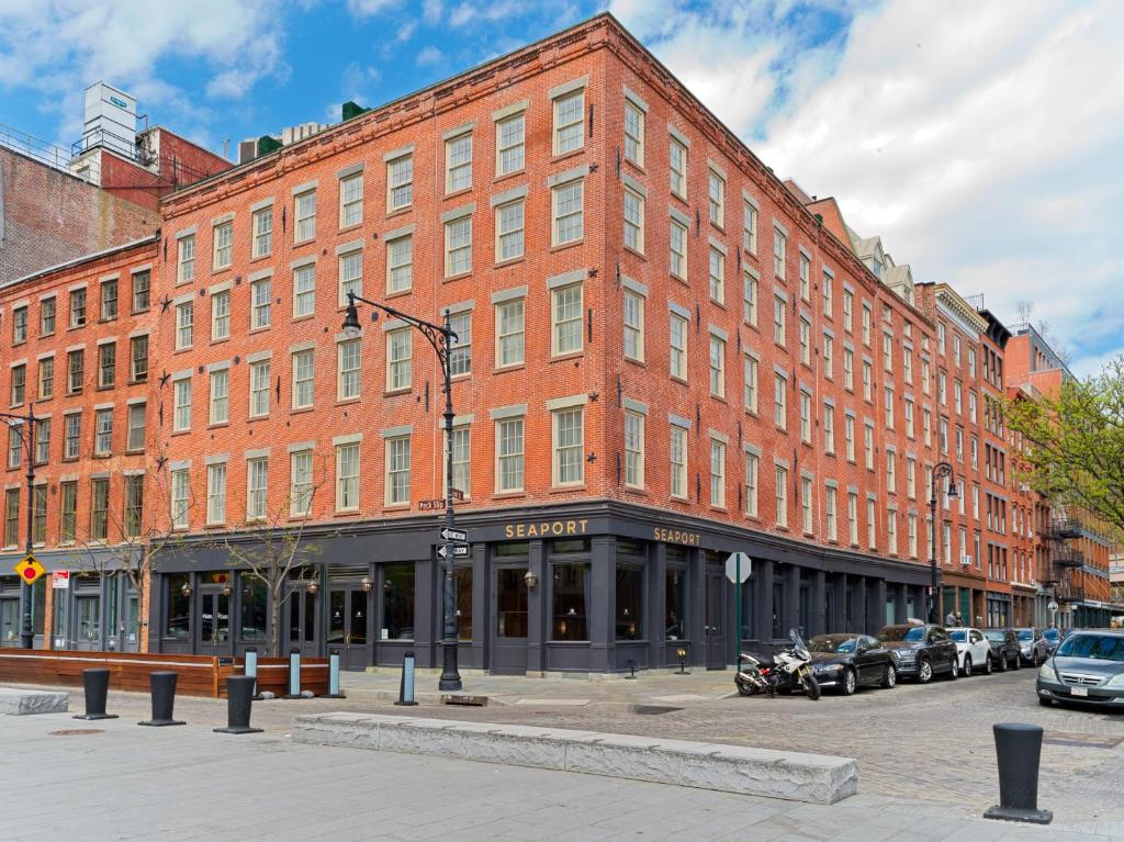 un grand bâtiment en briques avec des voitures garées devant lui dans l'établissement 33 Seaport Hotel New York, à New York