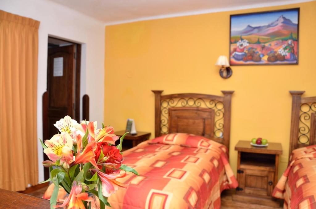 Postel nebo postele na pokoji v ubytování Hostal Mallqui