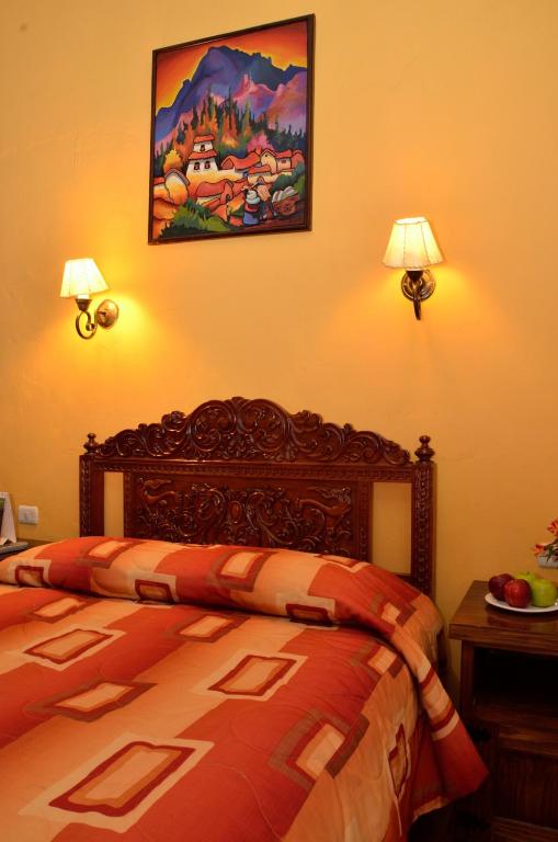Postel nebo postele na pokoji v ubytování Hostal Mallqui