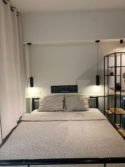 a bedroom with a large bed with two pillows at E2G URBAN STAY with Balcony in Thessaloniki