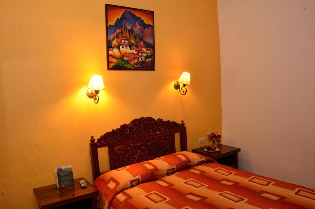 Postel nebo postele na pokoji v ubytování Hostal Mallqui