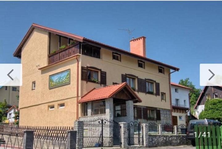 a large building with a fence in front of it at Willa ASPEN in Szklarska Poręba