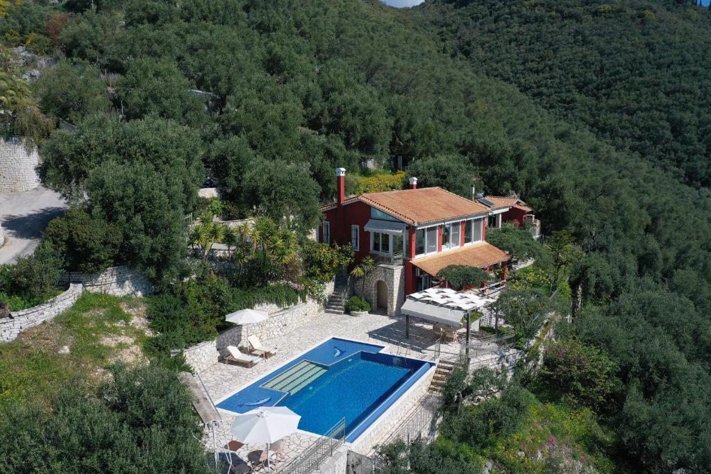 an aerial view of a house with a swimming pool at Zeitouni Lodge in Katávolos