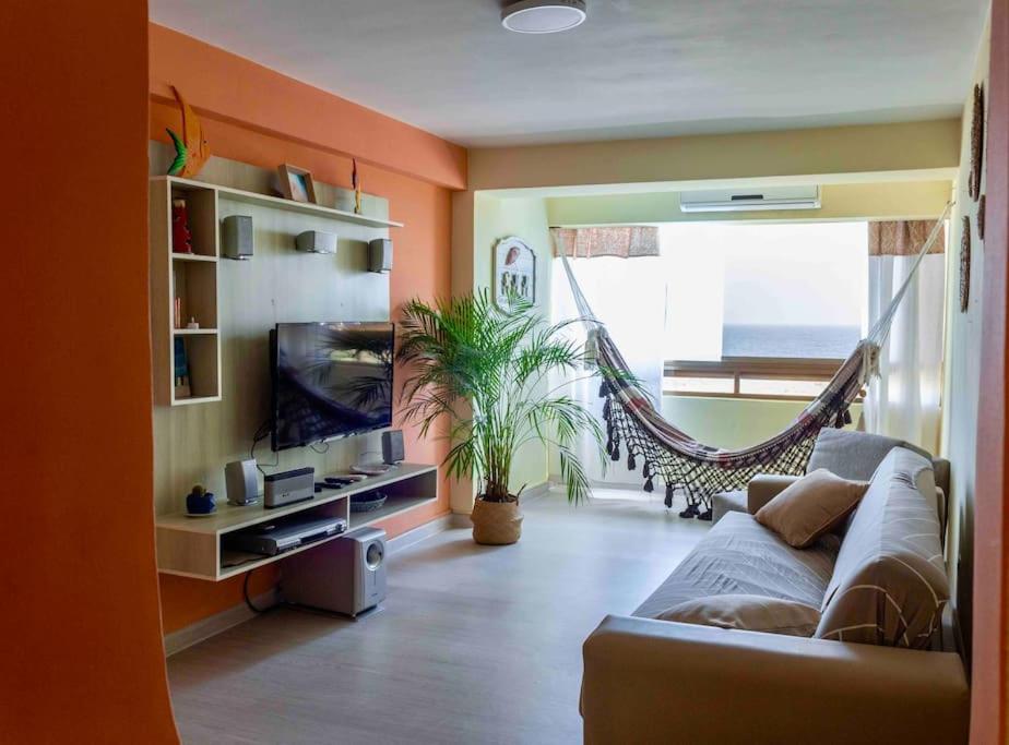 a living room with a couch and a hammock at Ritasol Palace apartamento de relax frente al mar in Caraballeda