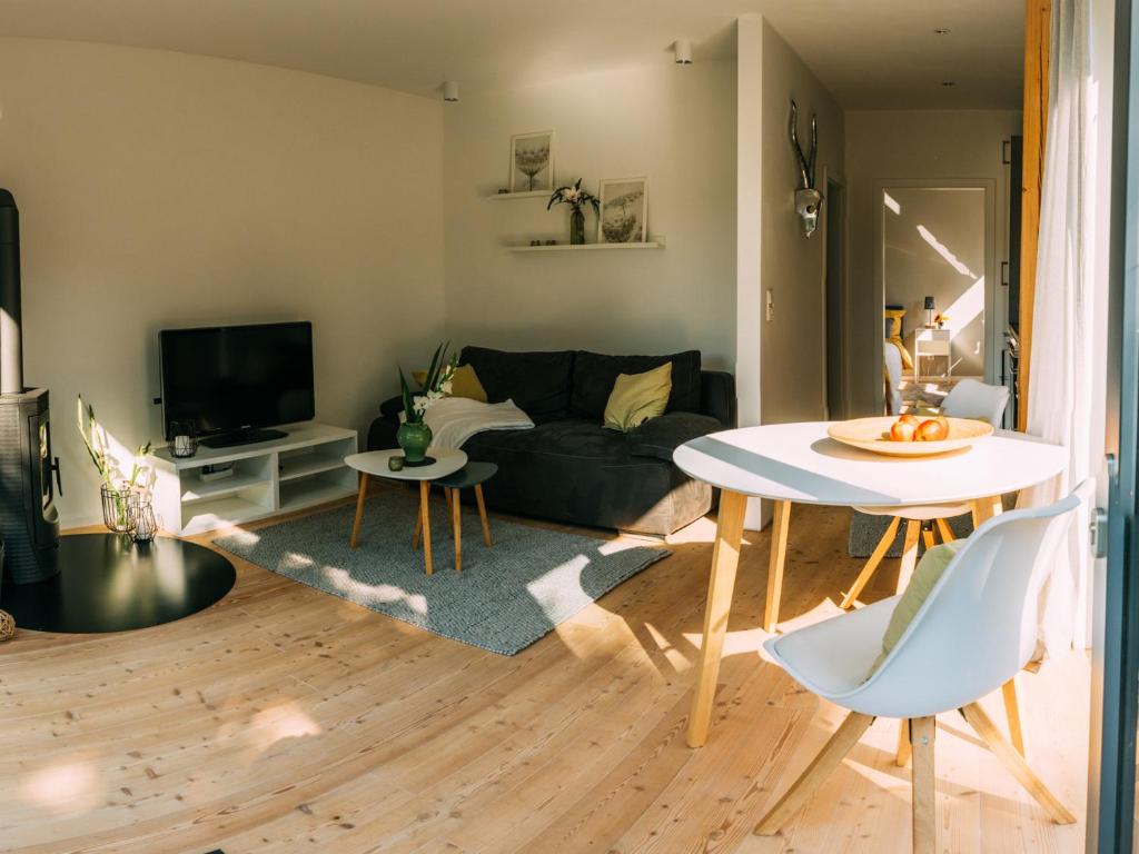 a living room with a couch and a table at NEU! Ferienhaus Handeloh in Handeloh