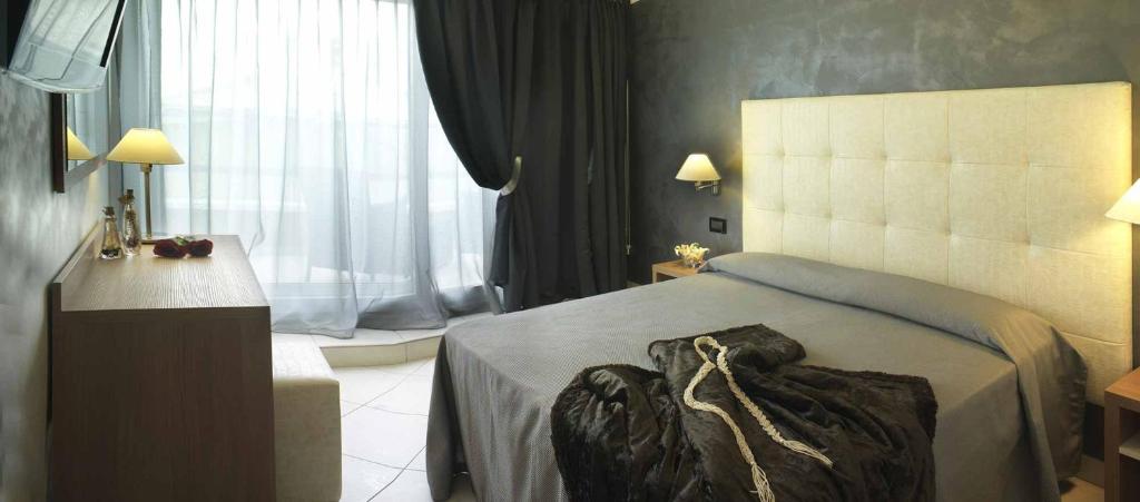 Postel nebo postele na pokoji v ubytování Hotel Petronio