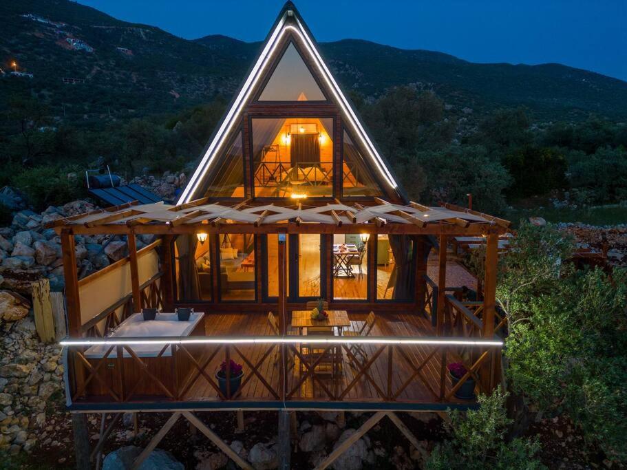 a large wooden house with a lit up roof at Hidden Bungalow in Kas