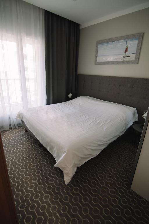 Postel nebo postele na pokoji v ubytování Merepargi ApartHotel & Cafe