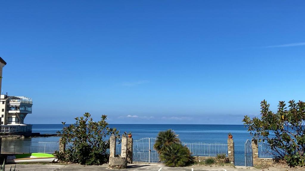 a view of the ocean from behind a fence at La Rosa Dei Venti in Acciaroli
