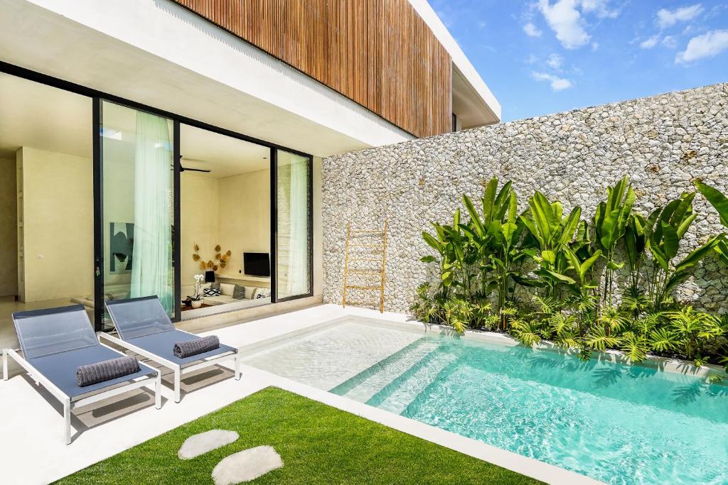 チャングーにあるCasa Umalas Villa by Betterplaceの家の裏庭にあるプール