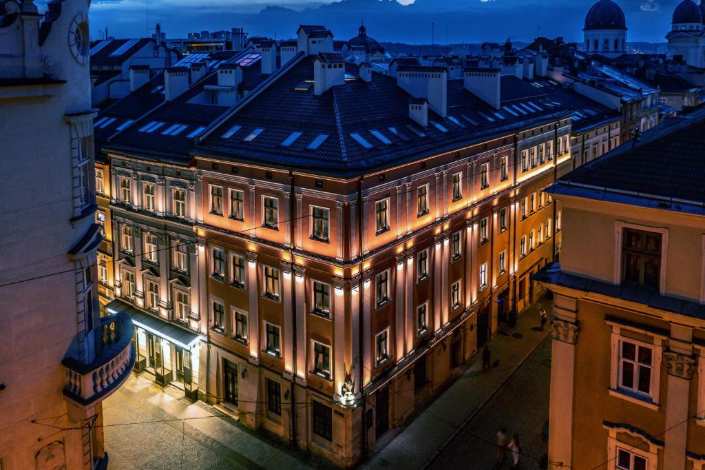 a building lit up at night with lights at Best Western Plus Market Square Lviv in Lviv