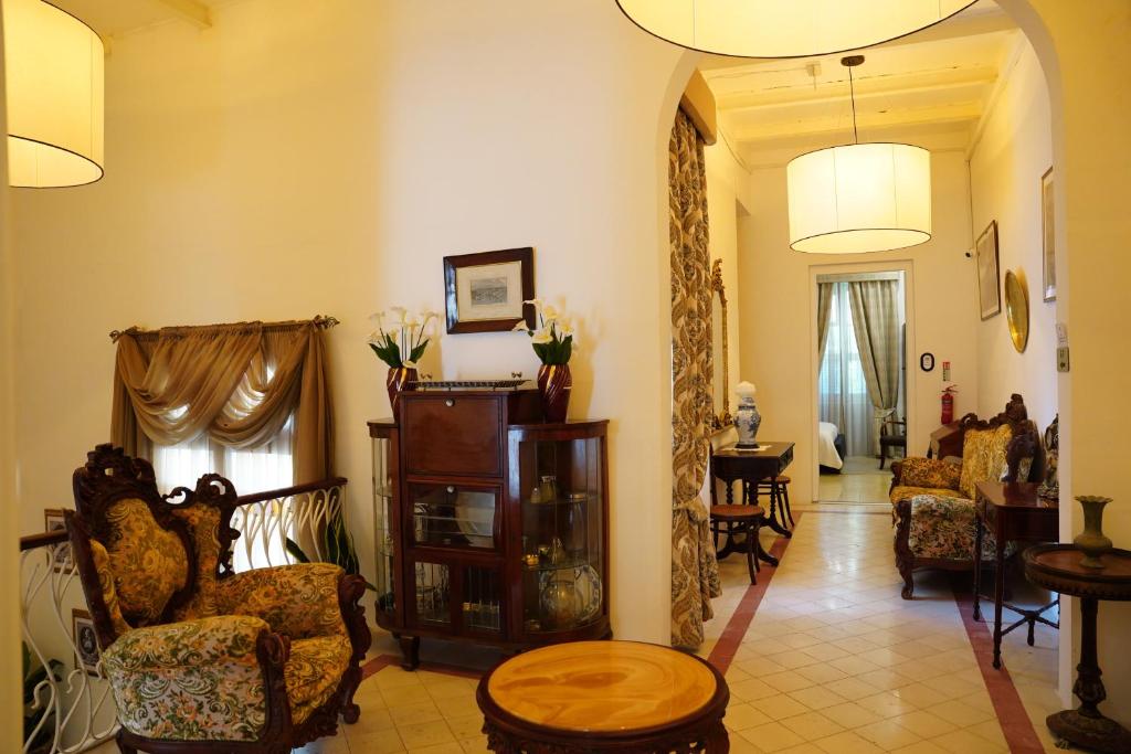 a living room with several chairs and a table at The Maltese Sun in Sliema