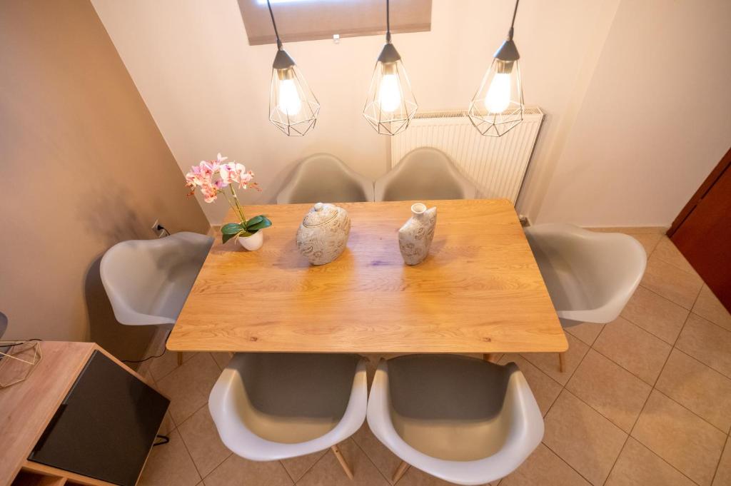 a dining room table with two figurines on it at Iasonas House 85m2 in Preveza