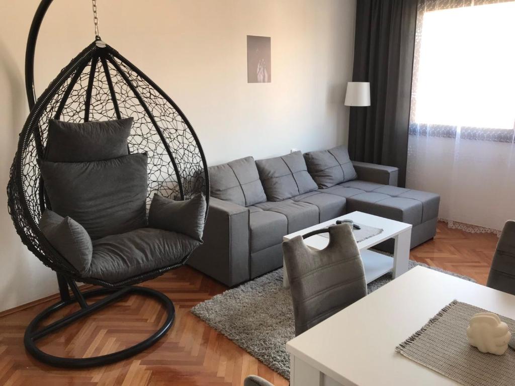 a living room with a couch and a swing at Apartman Snezana in Pirot