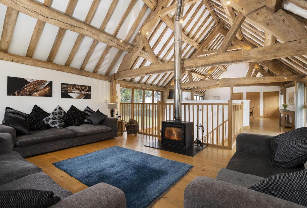 a living room with a wood burning stove in it at Wall Hills Barn in Bromyard