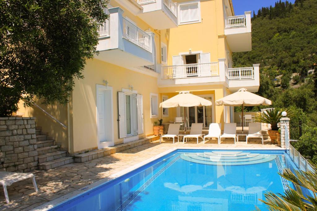 a villa with a swimming pool and a house at Villa Kyriaki in Kalami