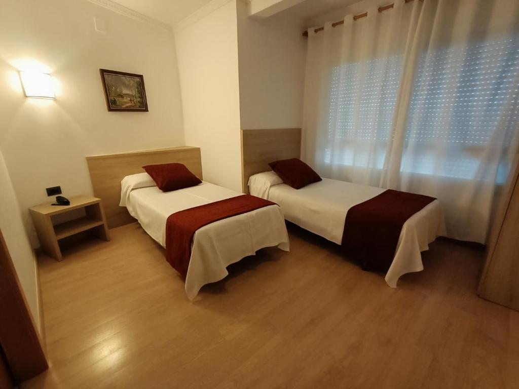 Postel nebo postele na pokoji v ubytování Hotel Vilobi