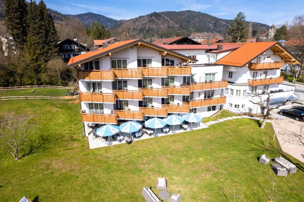 an aerial view of a resort building with tables and umbrellas at Schnitzers Dahoam - Hundefreundlich in Bad Wiessee