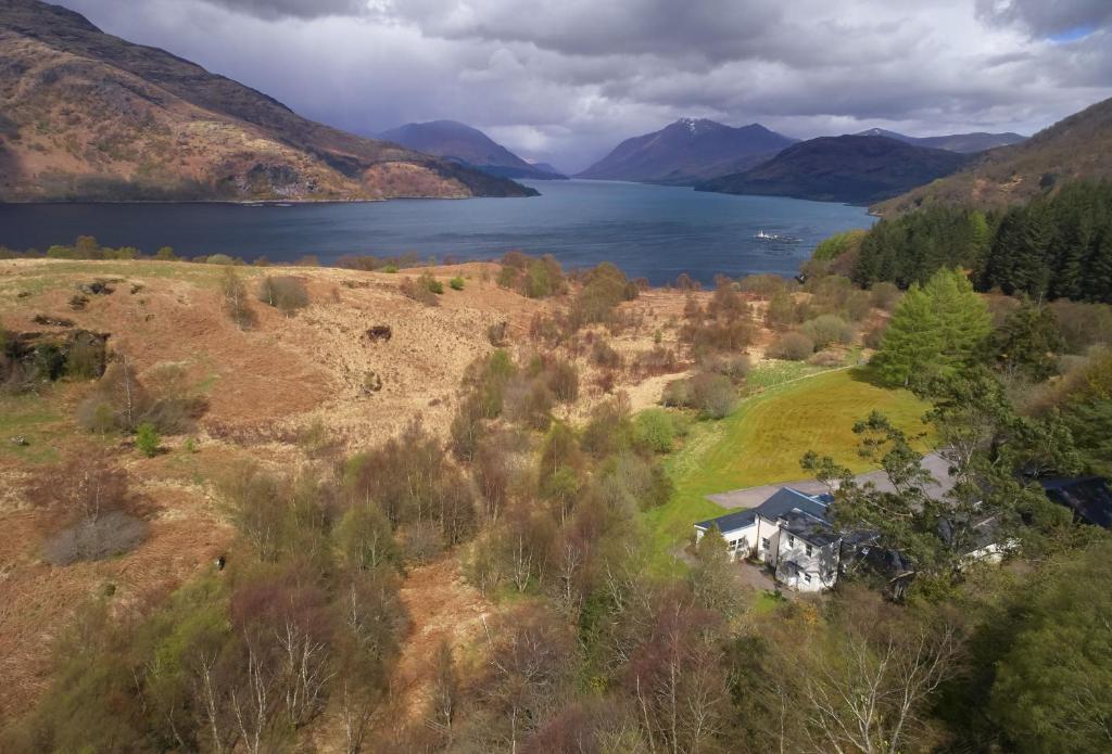 an aerial view of a house on a hill next to a lake at Port na Mine in Bonawe