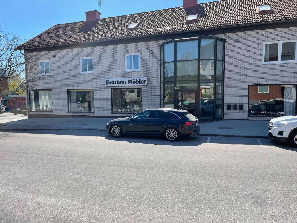 a black car parked in front of a building at RFM Tingsryd in Tingsryd
