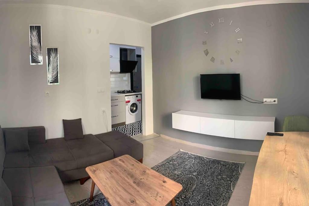 a living room with a couch and a table and a tv at Lux apartment in Cafeler caddesi in Antalya