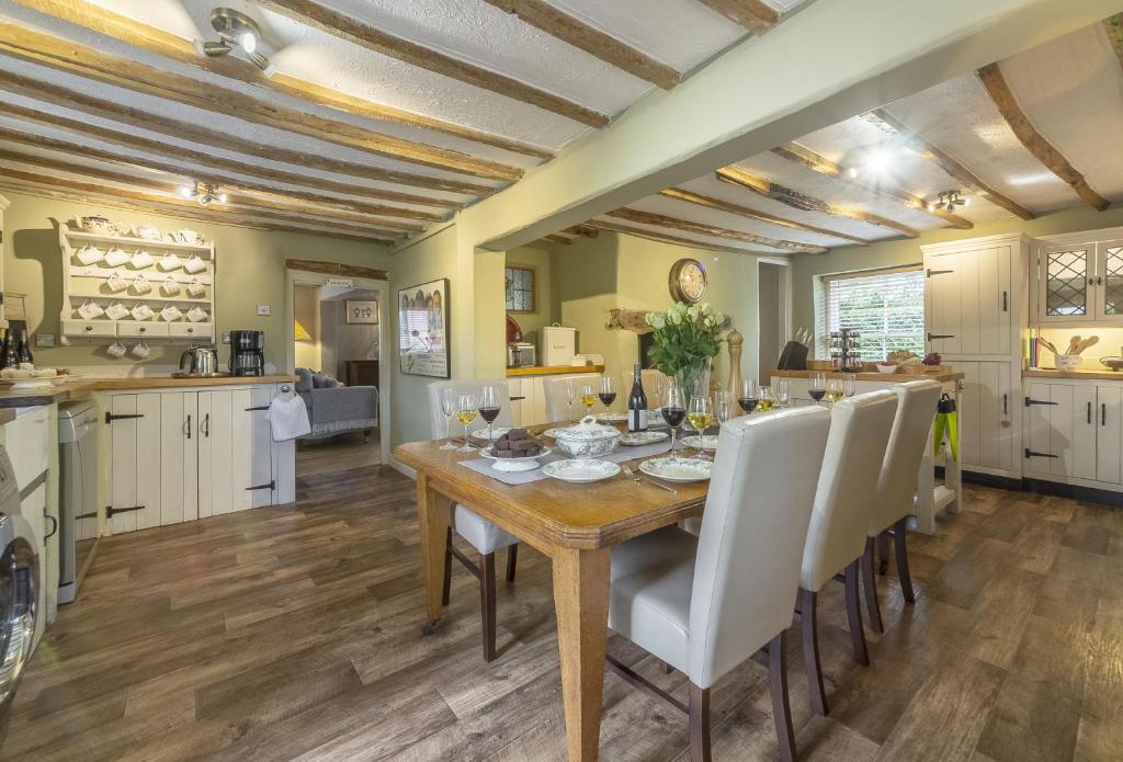 a kitchen and dining room with a wooden table and chairs at Pillar Box House in Kimberley