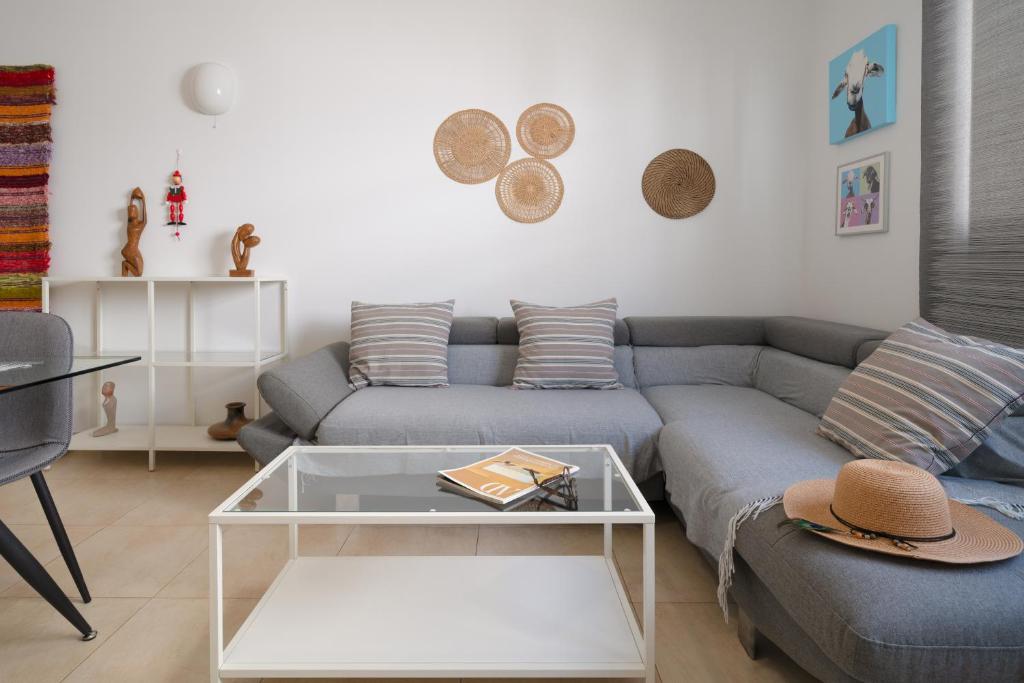 a living room with a couch and a table at Sabbia Suites Casa Nina in Arrecife