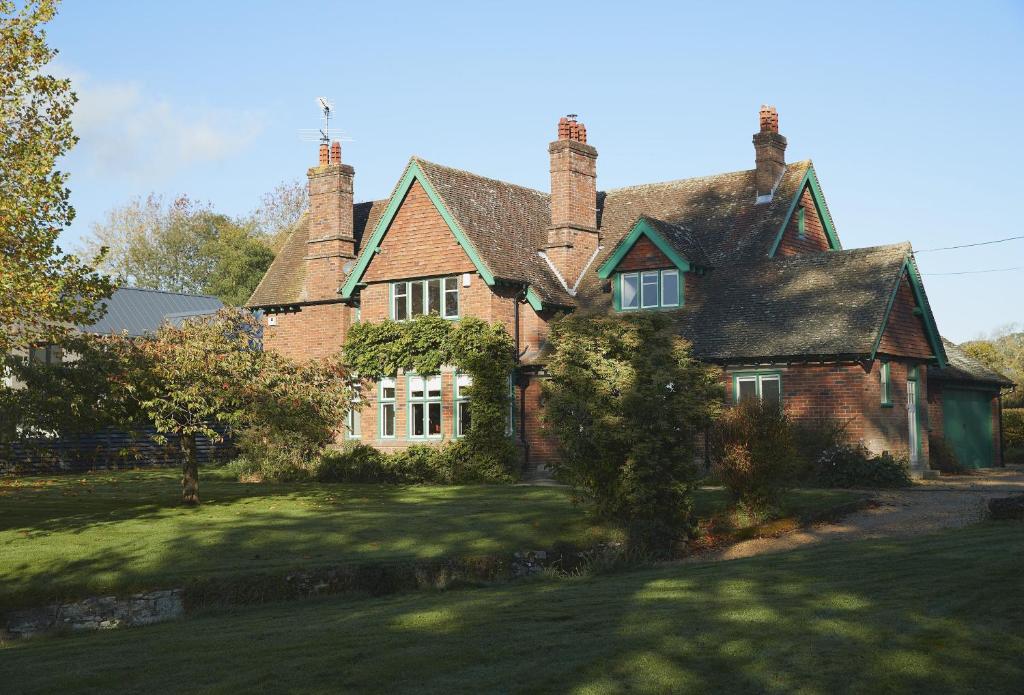 a large brick house with a grass yard at Green Gables in Eardisley