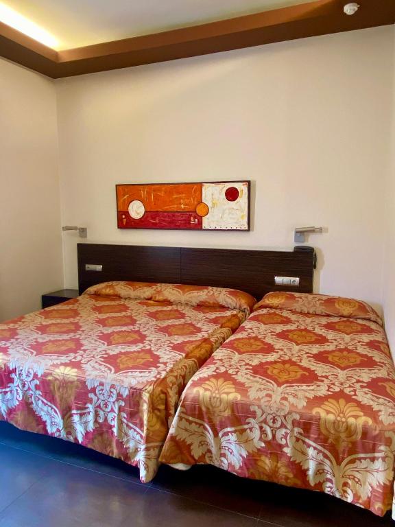 Cama o camas de una habitación en Hospedium Hotel Los Periquitos