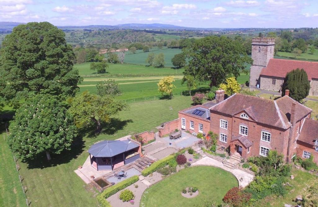 an aerial view of a large brick house at Broad Meadows Farmhouse 8 Guests in Bayton