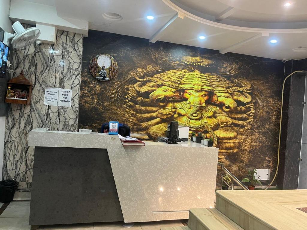 a wall with a mural of a gold statue at THE Flight path Unit By Urban Luxury Delhi Airport in New Delhi