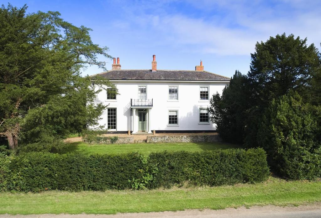 una gran casa blanca con árboles y arbustos en Walesby House, en Walesby