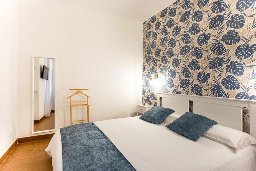 a bedroom with a large white bed with blue pillows at Charming Canonica Apartments in Milan