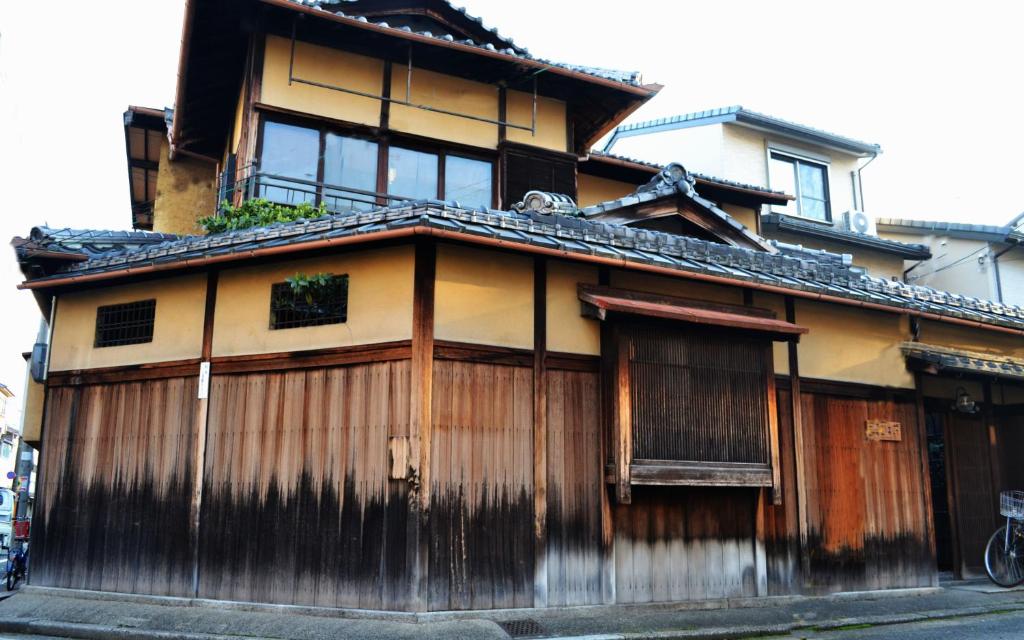 an old house with a building at Higurashi-sou in Kyoto