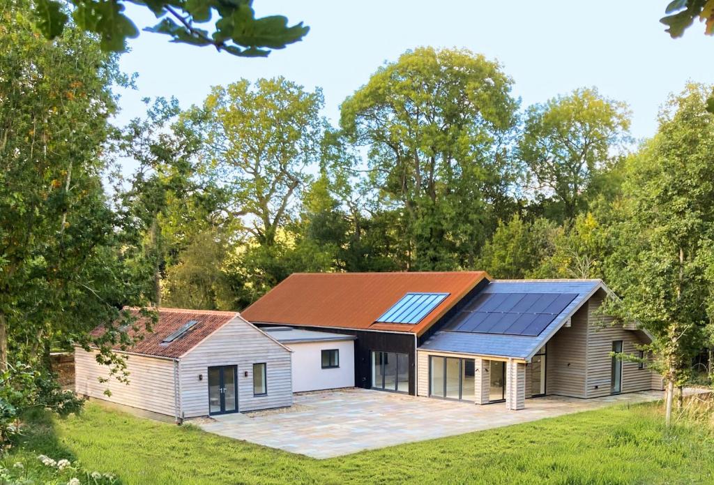 a home with solar panels on the roof at Missy's House in the Woods in Harringworth