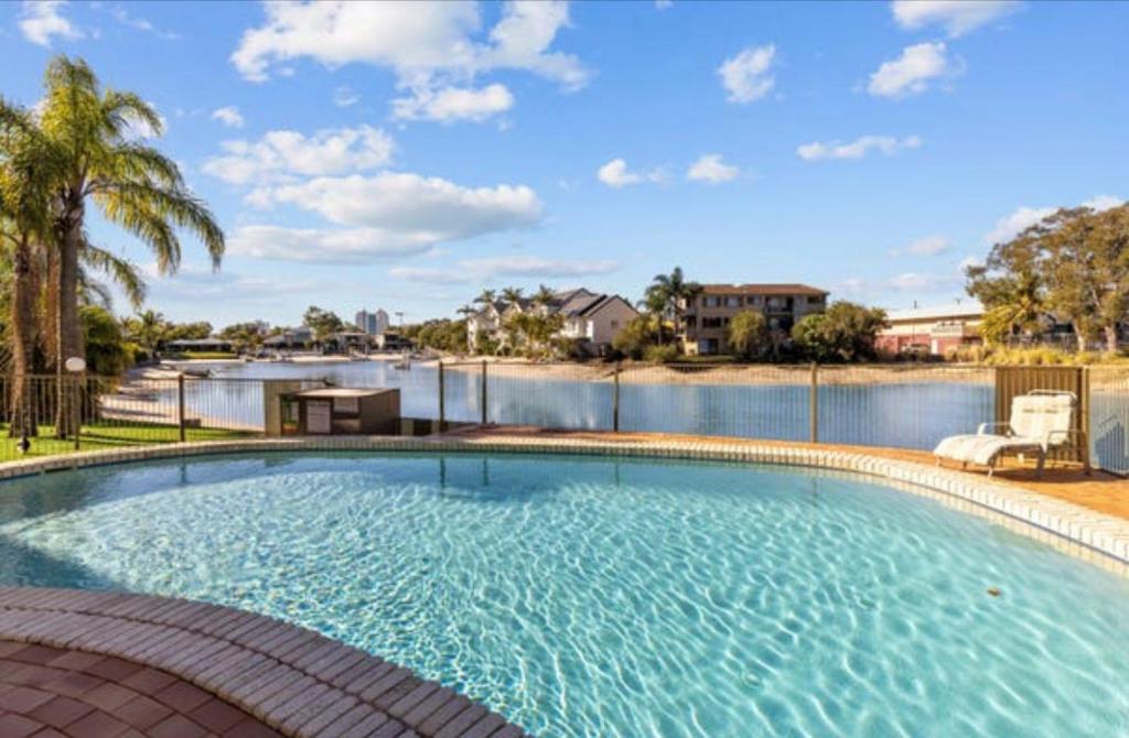 a large swimming pool with a view of a river at Mooloolaba Waterfront Unit - sleeps 8 in Mooloolaba