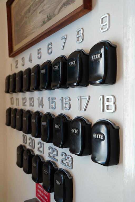 a bunch of black clocks on a wall at The Maltese Sun in Sliema
